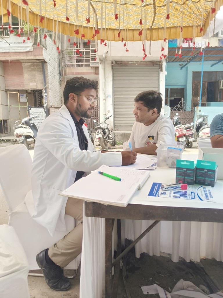 Dr. Neeraj consulting a patient at a community health camp