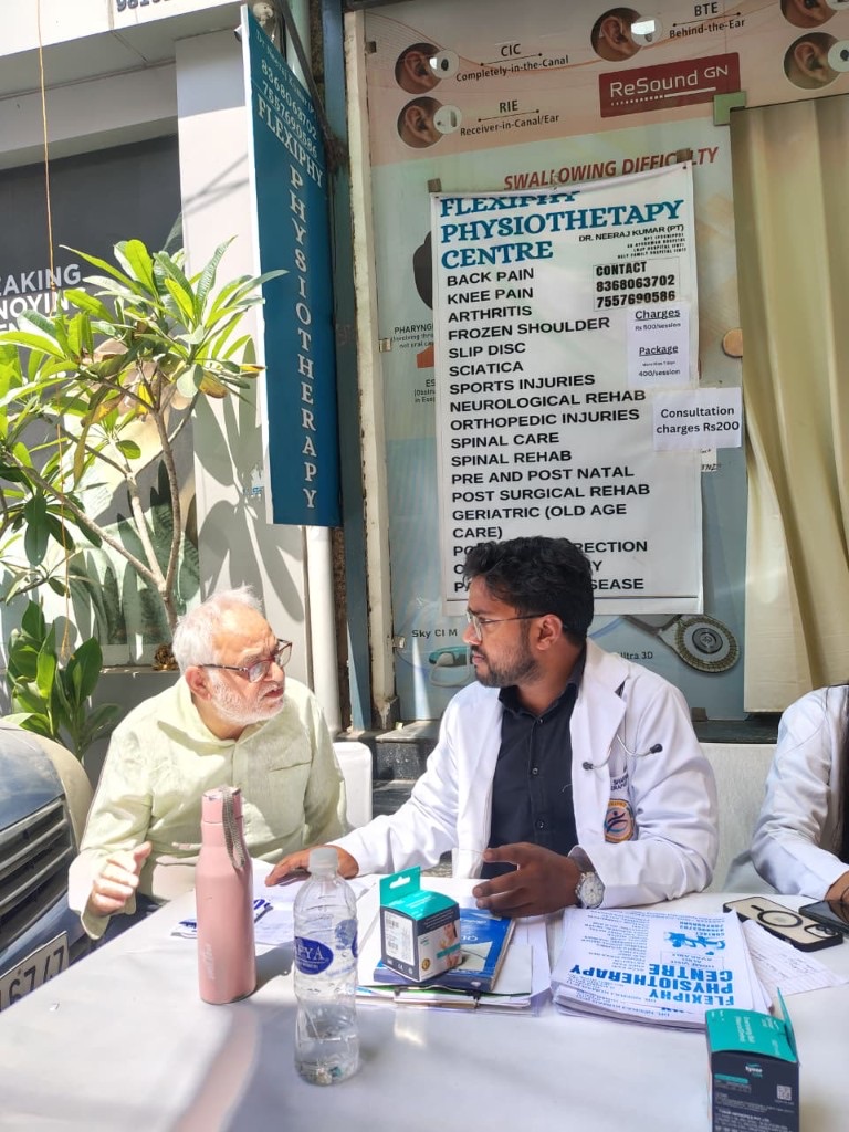 Dr. Neeraj consulting a senior patient outside Flexiphy Physiotherapy Centre